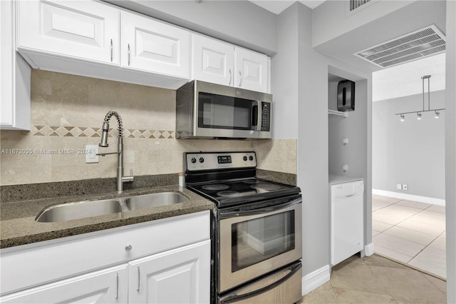3300 NE 192nd St Unit 1108, Aventura, FL 33180 - kitchen featuring stainless steel appliances, a sink, decorative backsplash, white cabinets, and dark stone countertops