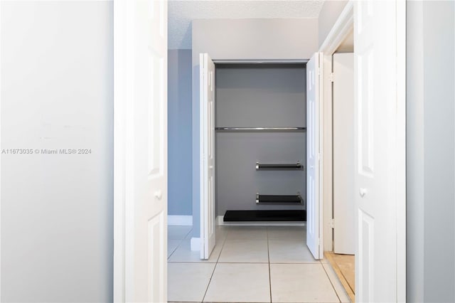 3300 NE 192nd St Unit 1108, Aventura, FL 33180 - hall featuring light tile patterned floors, a textured ceiling, and baseboards