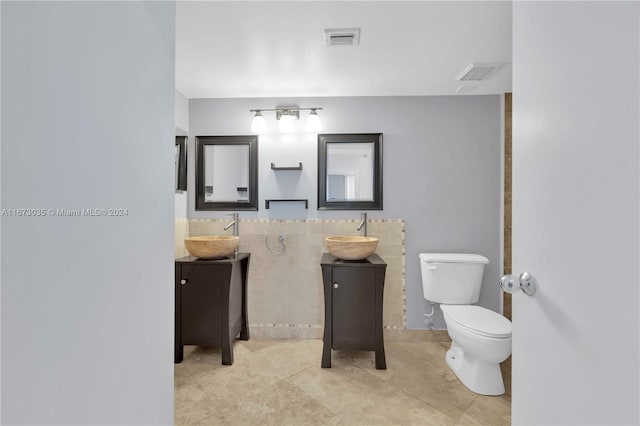 bathroom with vanity, tile patterned flooring, and toilet