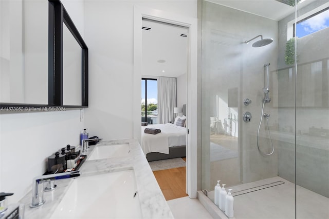 bathroom with vanity, hardwood / wood-style flooring, and tiled shower