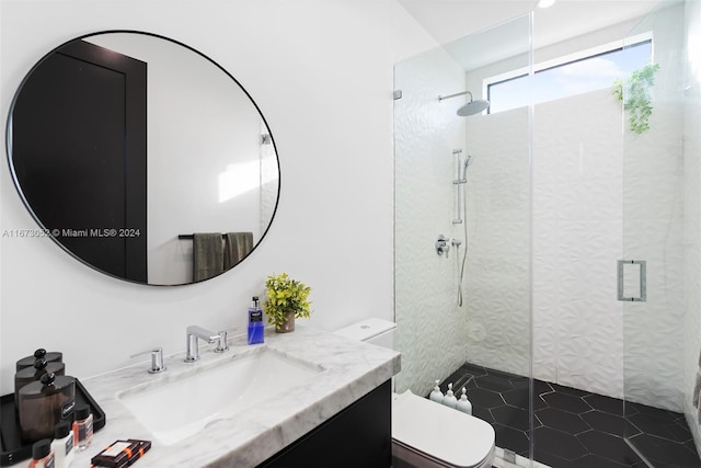 bathroom with walk in shower, vanity, and toilet