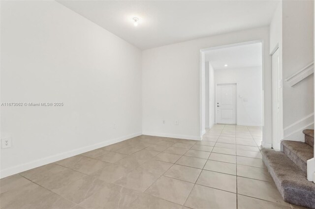 unfurnished room featuring light tile patterned floors