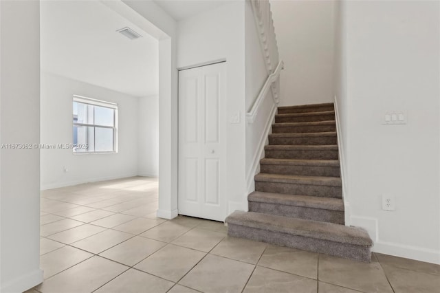 stairs with tile patterned floors