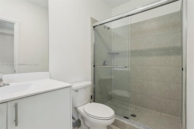 bathroom with toilet, a shower with door, and vanity