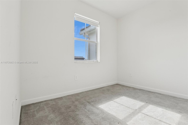 spare room featuring light colored carpet