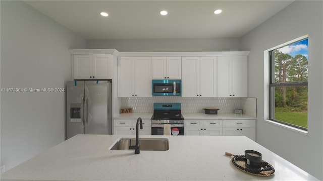 932 Maddock St, Lehigh Acres, FL 33974 - kitchen with stainless steel appliances, tasteful backsplash, recessed lighting, white cabinets, and light stone countertops