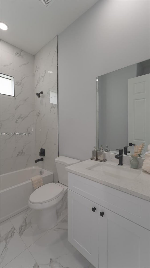 full bathroom featuring toilet, tiled shower / bath combo, and vanity