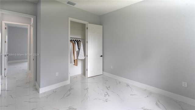 932 Maddock St, Lehigh Acres, FL 33974 - unfurnished bedroom with marble finish flooring and a closet