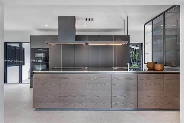 kitchen with sink, island exhaust hood, and black double oven