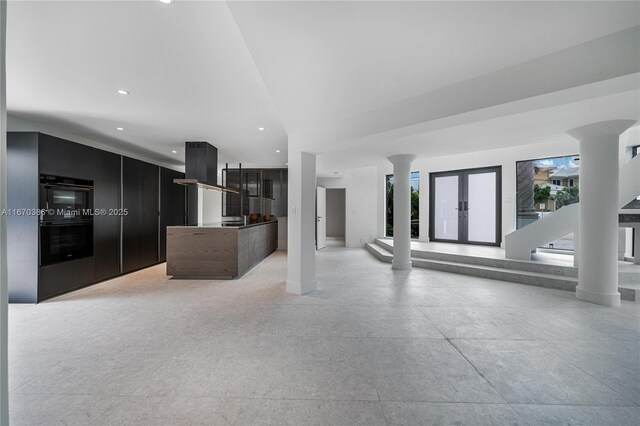 kitchen featuring french doors and multiple ovens