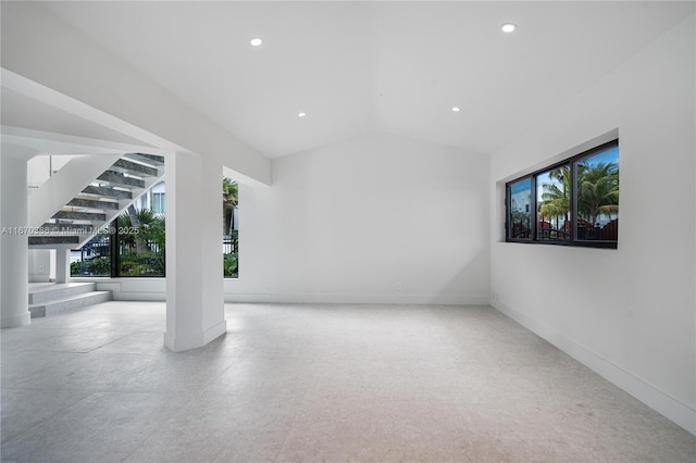 unfurnished room featuring vaulted ceiling