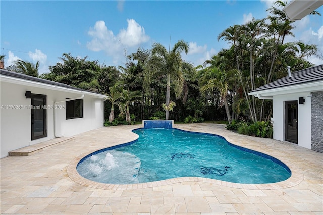 view of swimming pool featuring pool water feature and a patio