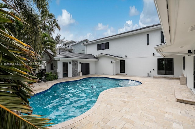 view of swimming pool with a patio area