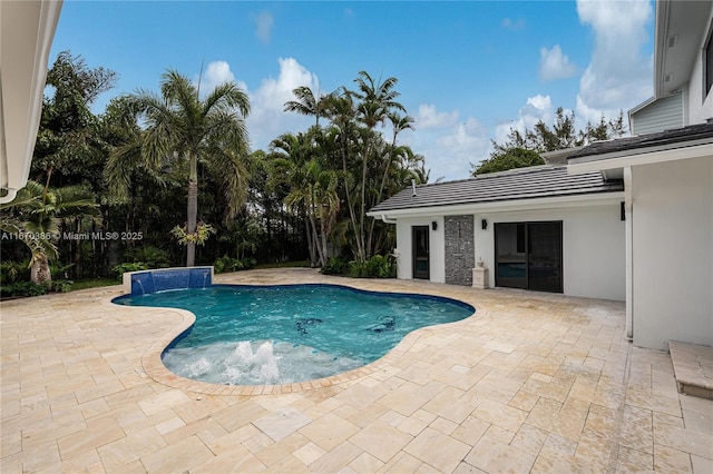 view of pool with pool water feature and a patio