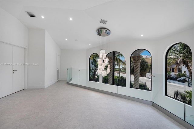 spare room with lofted ceiling