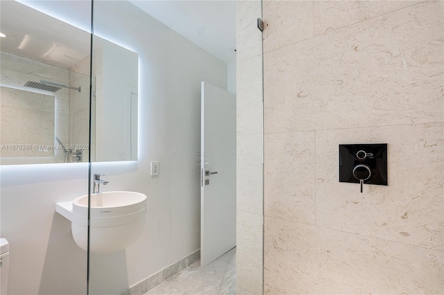 bathroom featuring sink, toilet, and walk in shower