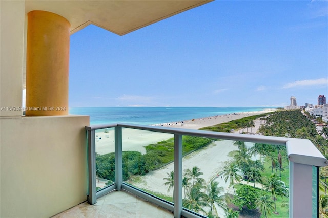 balcony with a water view and a beach view