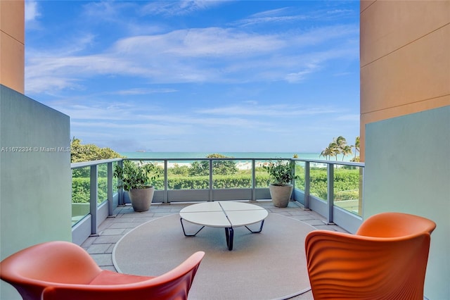 balcony with a water view and a beach view