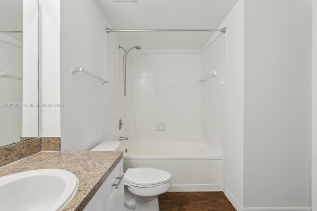 full bathroom featuring vanity, hardwood / wood-style flooring, toilet, and tiled shower / bath combo