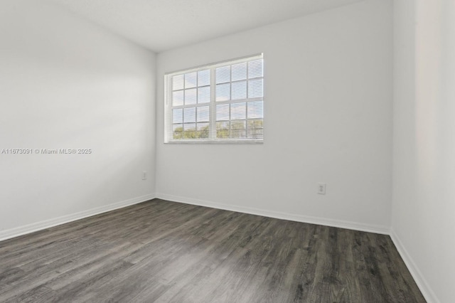 spare room with dark wood-type flooring