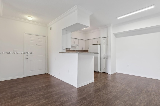 kitchen featuring white appliances, dark wood-type flooring, crown molding, kitchen peninsula, and white cabinetry