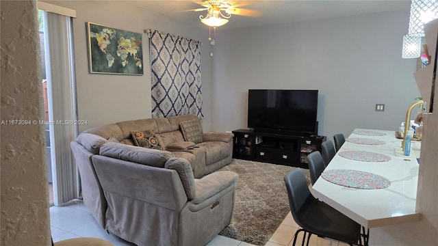 living room featuring light tile patterned floors and ceiling fan