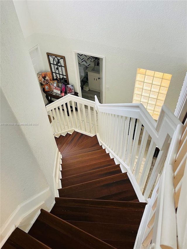 staircase featuring wood-type flooring