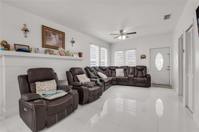 living room featuring ceiling fan and light tile patterned floors