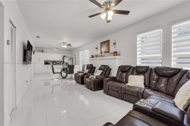 living room with light tile patterned floors, ceiling fan, and a healthy amount of sunlight