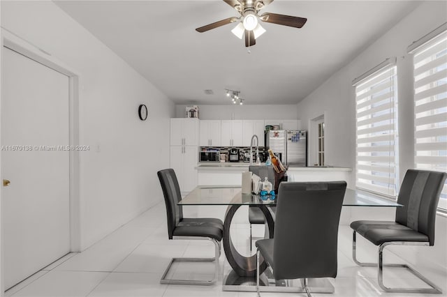 tiled dining space with ceiling fan