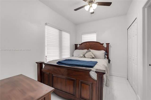 bedroom with a closet, ceiling fan, and light tile patterned floors