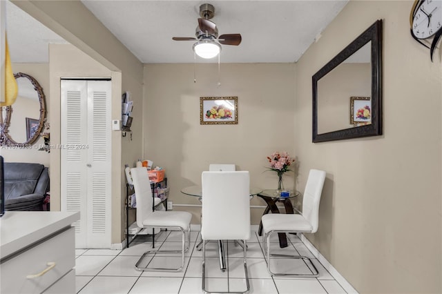 tiled dining space featuring ceiling fan