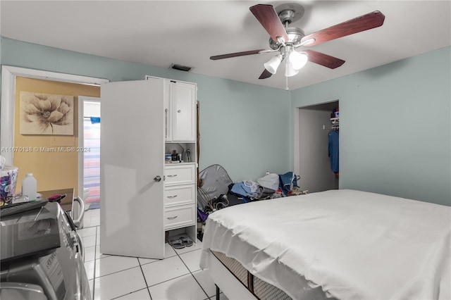 tiled bedroom featuring ceiling fan and washer / clothes dryer