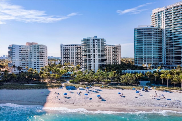 bird's eye view featuring a water view and a beach view