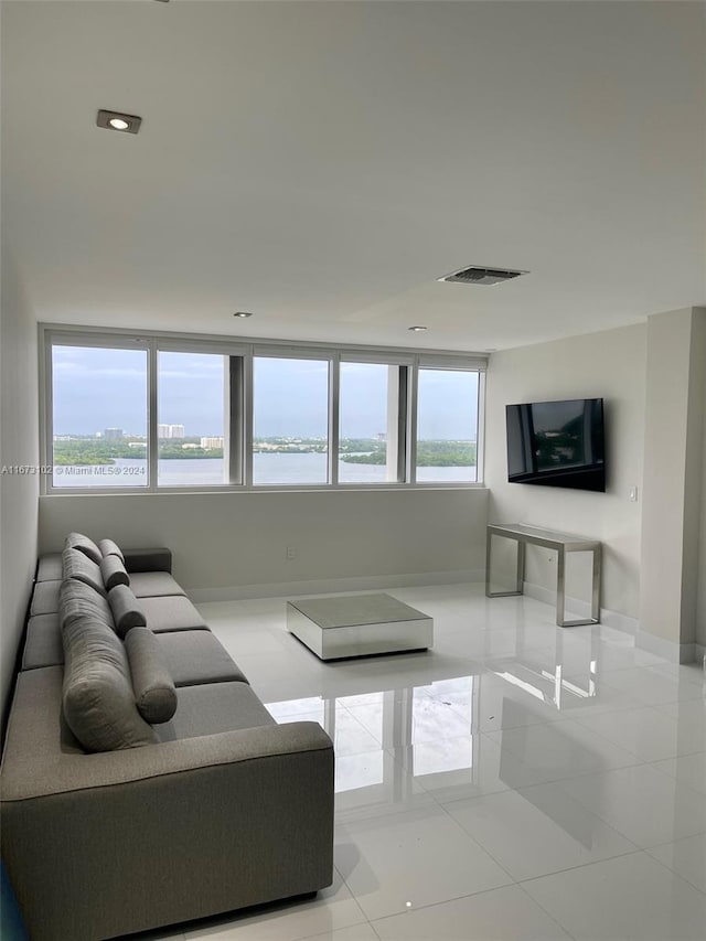 living room featuring light tile patterned flooring and plenty of natural light