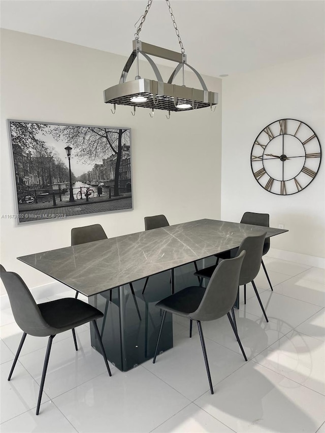 tiled dining space featuring a chandelier