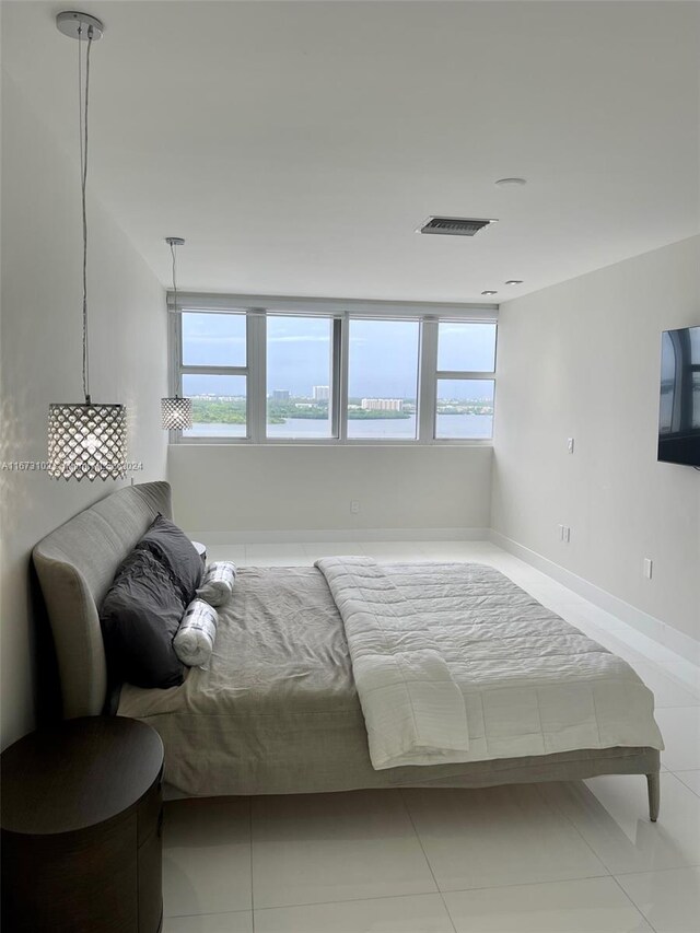 bedroom featuring multiple windows and light tile patterned floors