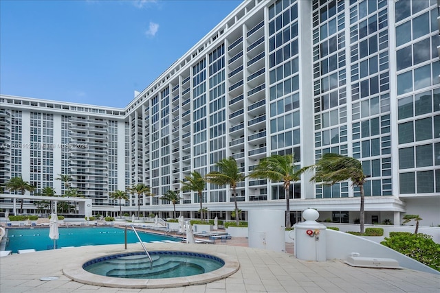 view of pool with a patio area and a community hot tub