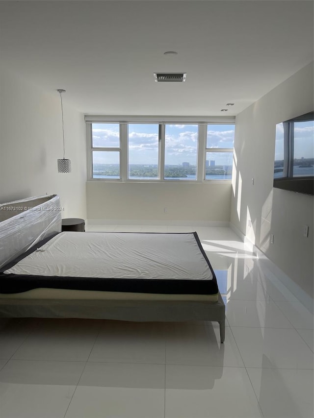 bedroom featuring light tile patterned flooring