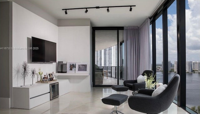 living room with beverage cooler and a wall of windows