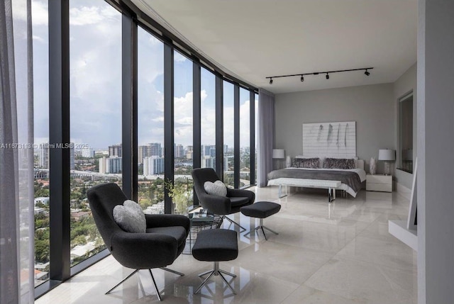 bedroom with track lighting and floor to ceiling windows