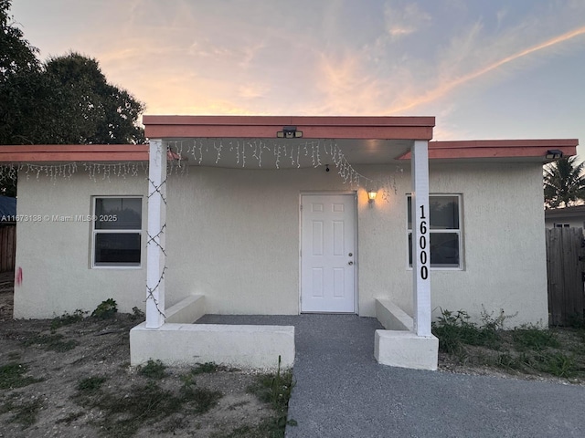 view of exterior entry at dusk