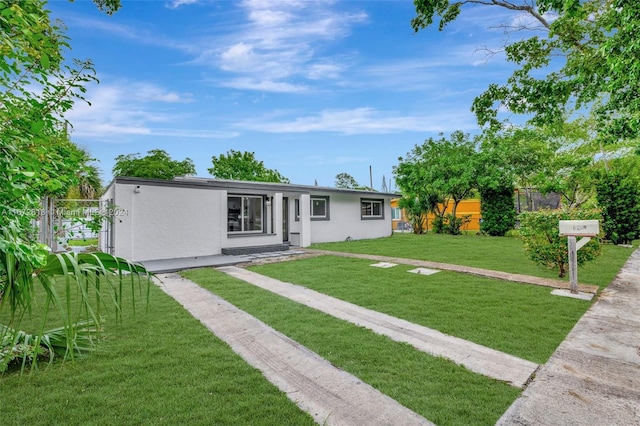 ranch-style home with a front yard