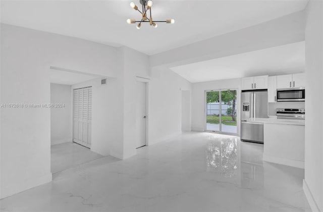 unfurnished living room featuring an inviting chandelier