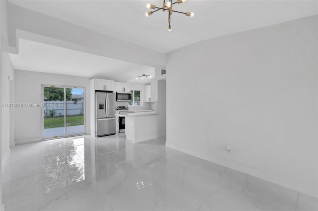 unfurnished living room featuring a chandelier