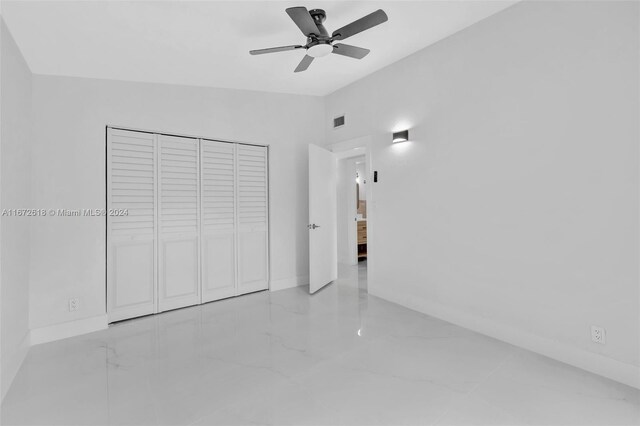 unfurnished bedroom featuring a closet and ceiling fan