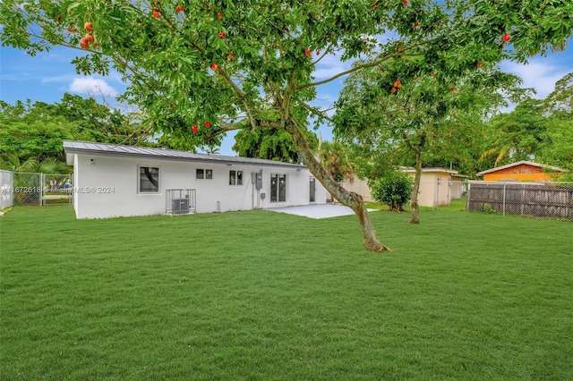 back of property with a patio, a lawn, and cooling unit