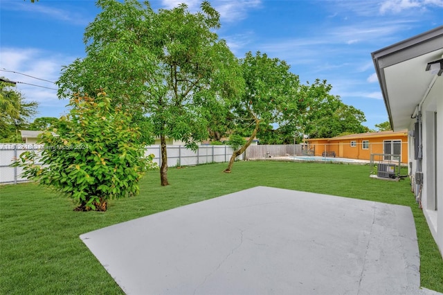 view of yard featuring a swimming pool and a patio area