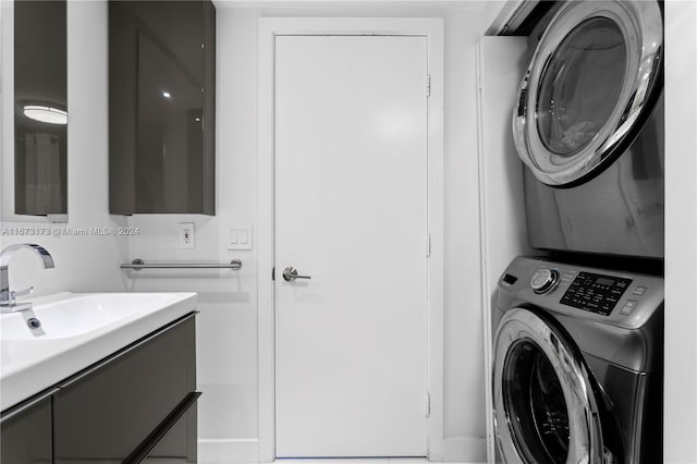 laundry area featuring stacked washer and dryer and sink