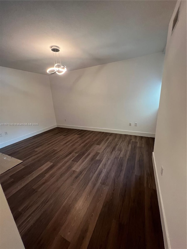 spare room with dark wood-type flooring